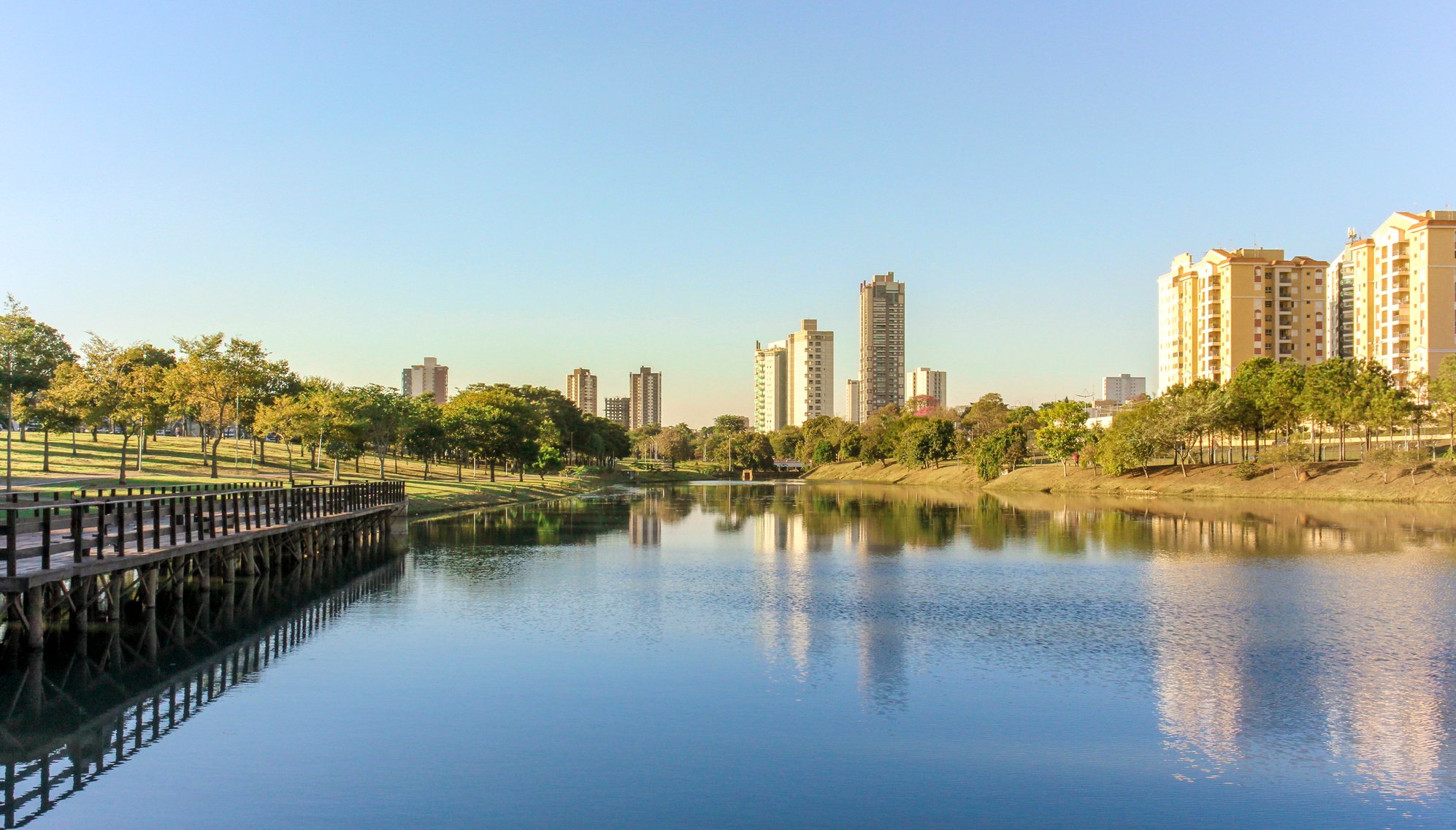 Late afternoon in the ecological park of Indaiatuba with lake reflecting the trees and buildings